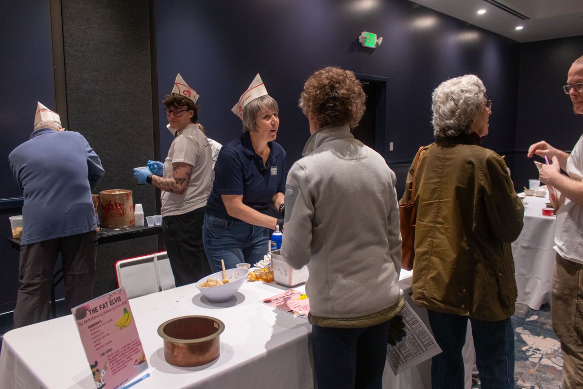 Volunteers preparing sundaes at a tasting station
